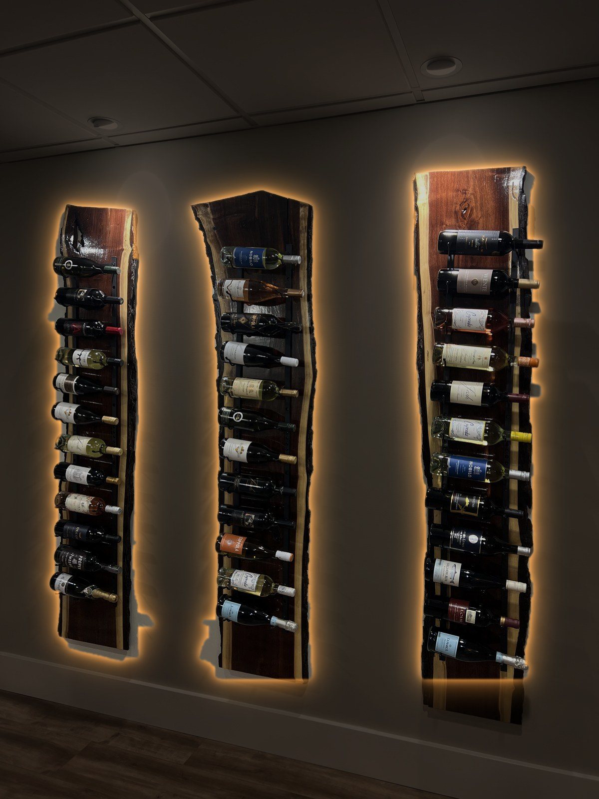 The same three racks with warm LED backlighting at night